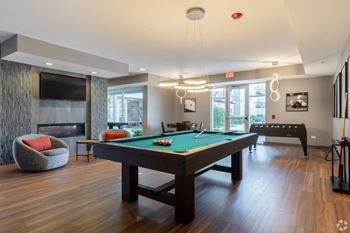 a pool table in a living room with a tv